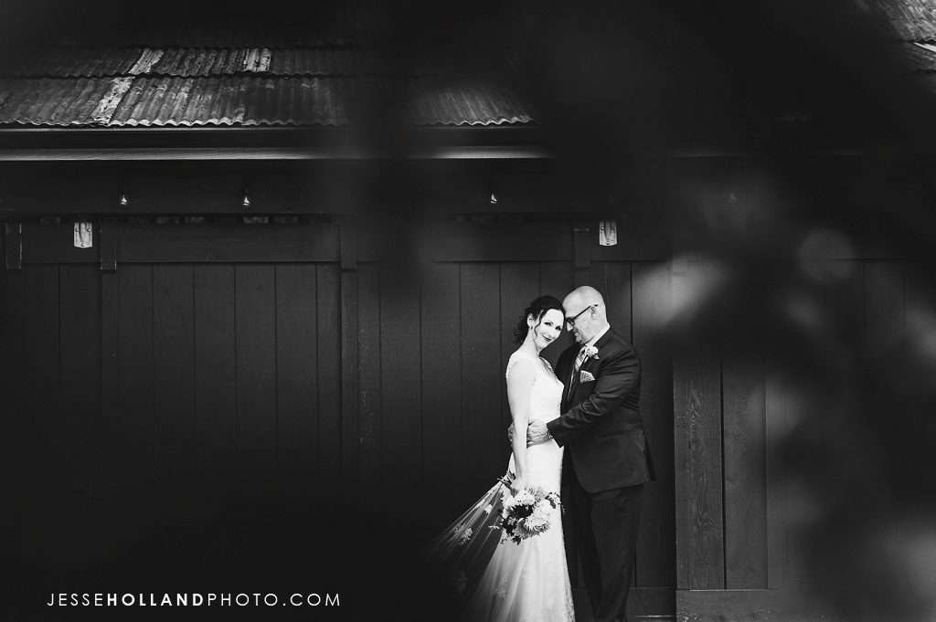 Couple in front of barn in black and white